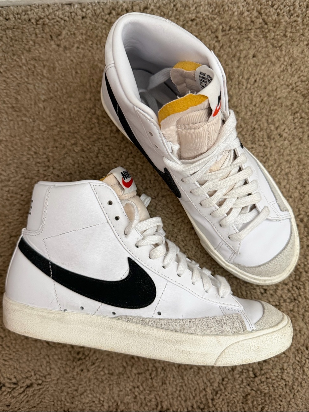 Nike White High-Top Sneakers with Black Swoosh and Yellow Tongue Detail